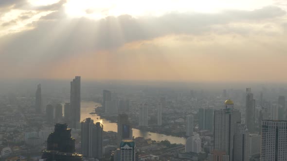High view of Bangkok with Sun Light and Pollution along the Chao Phraya River. Thailand