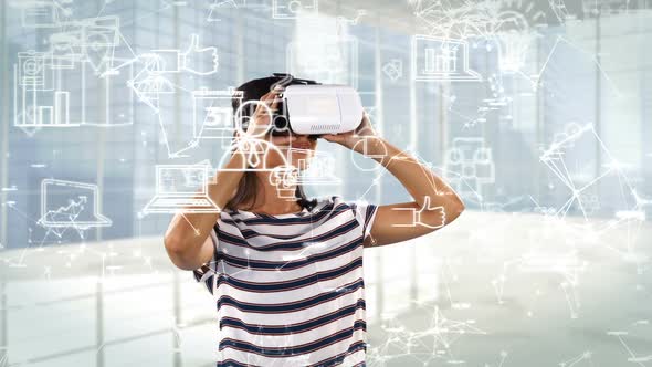 Woman using virtual reality headset with digitally generated business icons
