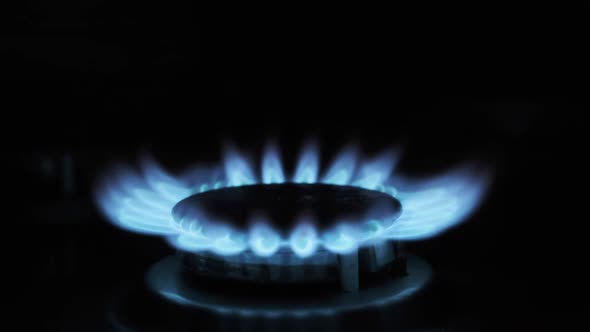 Gas Ignition on the Burner on a Dark Background Closeup