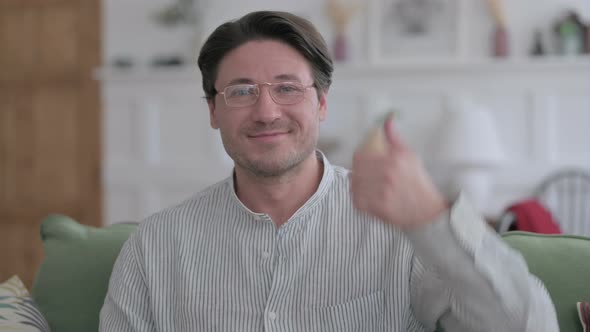 Portrait of Man Showing Thumbs Up at Home