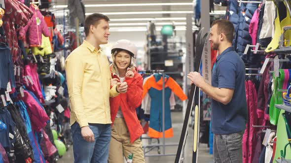 Customers and Consultant Stand in the Department of Snowboards and Skis.