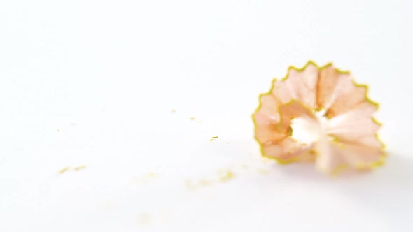 Yellow color pencil shavings on a white background