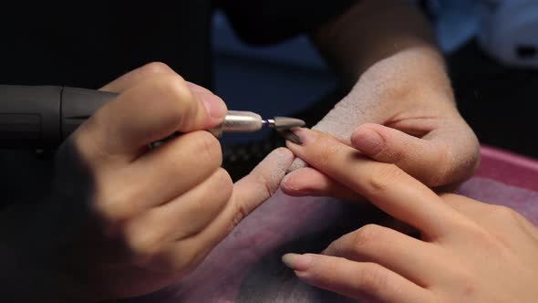 Anonymous Beautician Doing Manicure to Female Client