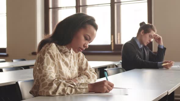 Female College Student Writing on Exam