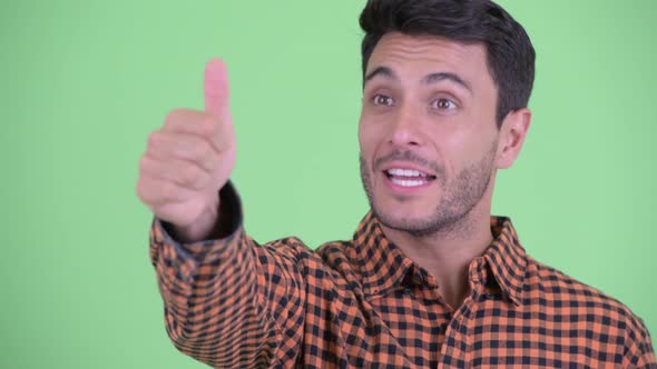 Face of Happy Young Hispanic Hipster Man Giving Thumbs Up