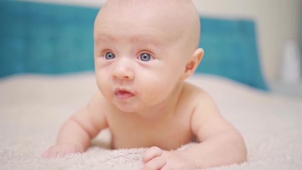 Funny and Beautiful Baby on the Bed