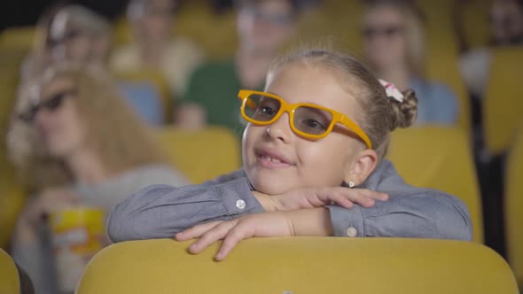 Charming Absorbed Caucasian Girl Watching 3d Film in Cinema. Portrait of Beautiful Little Child in