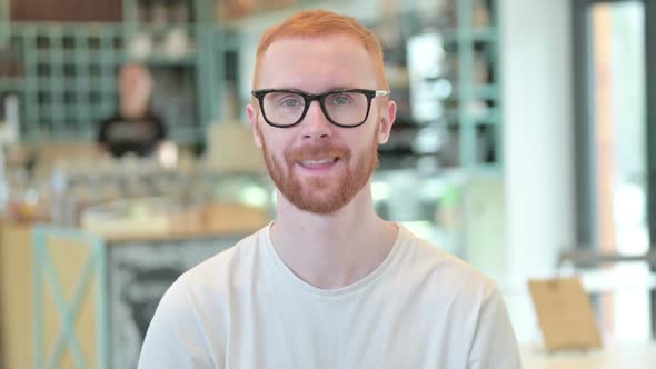 Portrait of Redhead Man Waving at the Camera