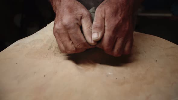 Potter's Hands Knead the Clay on Table with Special Napkin and Prepare It for Use in Production of