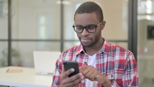 African Man Using Smartphone Browsing Internet