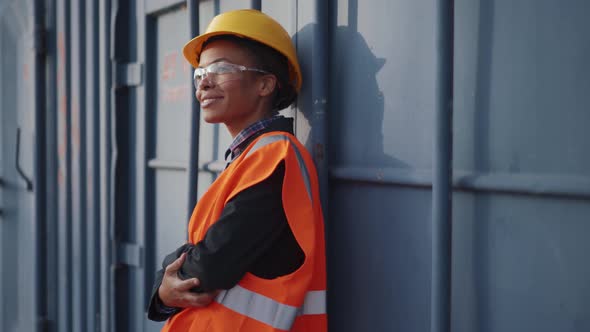 Shipbuilder women in uniform standing near container