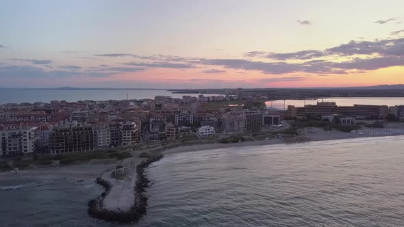 Aerial view of Pomorie city that is located on Black Sea shore at sunset. Top view of sand beaches