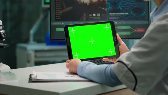 Back View of Chemist Woman Holding Tablet with Green Mockup