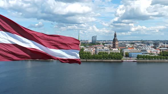 Latvian Flag with the Dome Cathedral and an Old Town in the Background in Riga Latvia