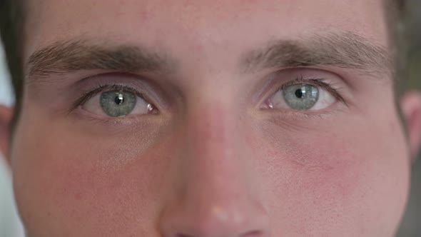 Close Up of Young Man Blinking Eyes in Camera