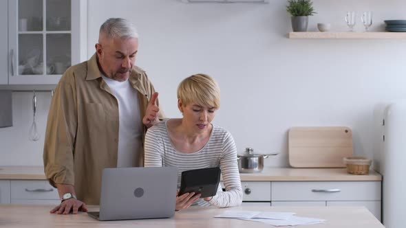 Discontented Couple Calculating Expenses Suffering From Crisis Paying Bills Indoors