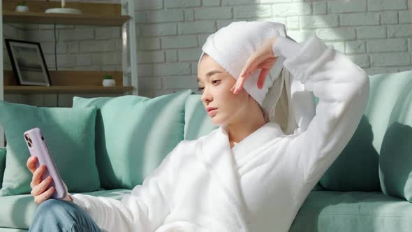 Girl in Bathrobe and with Bath Towel on Her Head is Making a Selfie