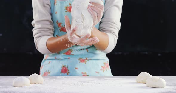 Woman kneading a dough 4k