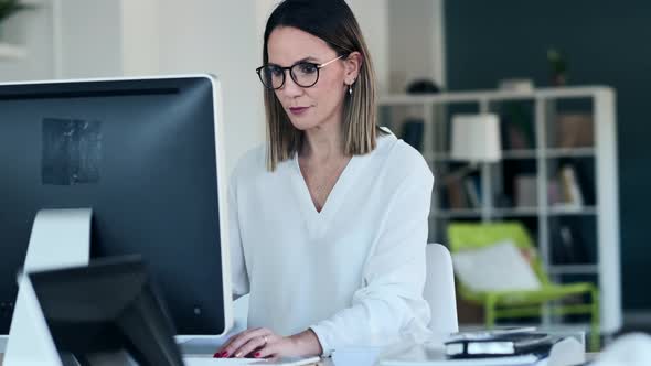 Slow motion shot of businesswoman using computer at the office