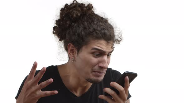 Closeup of Aggressive Hispanic Guy with Combed Hair Wearing Black Tshirt and Earrings Talking on