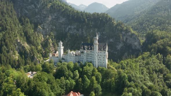 Panoramic View of Neuschwanstein Castle and Rocky Alps Mountains on the Background