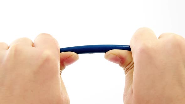 Hands breaking pencil in half on white background