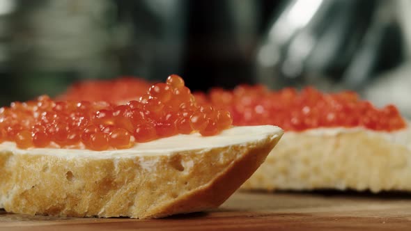 Putting Red Caviar on Bread and Butter Closeup of Caviar Sandwich