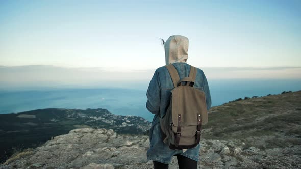 Woman Traveler with Backpack Walking and Enjoying View at Mountains