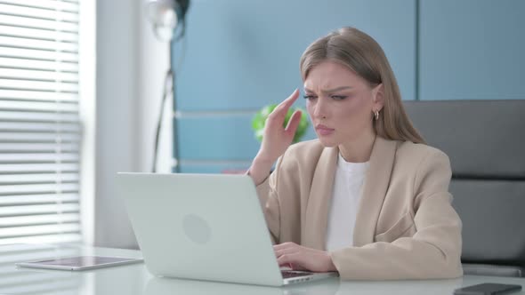 Woman Having Headache While Working on Laptop