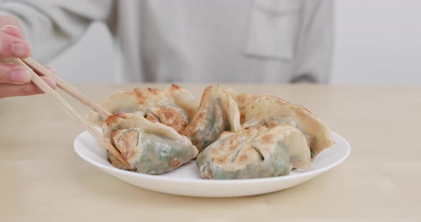 Eating grilled chinese meat dumpling 