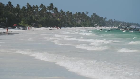 Paradise White Sandy Beach with Turquoise Ocean and Waves at Low Tide Zanzibar