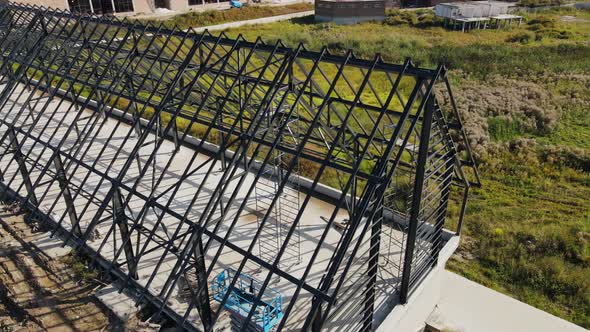 Aerial Flight Over a Large Metal Roof Structure. Metal Iron Partitions and the Roof Frame of a Large