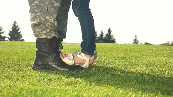 Soldier Feet with Boots and Little Daughter with Sandals