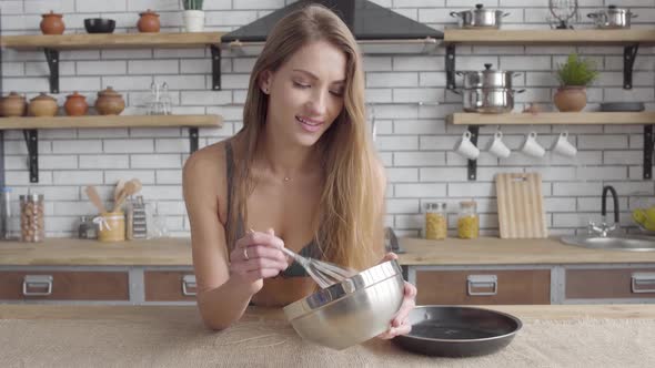 Portrait Pretty Young Woman in Lingerie Stiring a Whisk in a Large Bowl Standing in the Kitchen