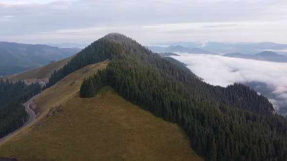 Mountain Peak Above Clouds Aerial View