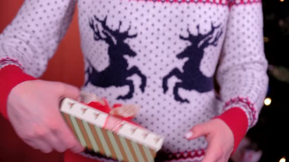 Woman Hands Gives a Gift for Christmas. Concept of Holidays, Christmas and New Year.