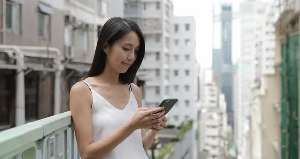 Woman use of mobile phone in city 