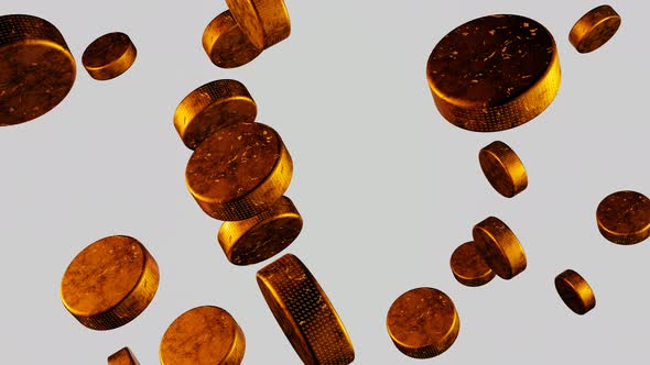 Many golden hockey pucks flying into camera on white background.