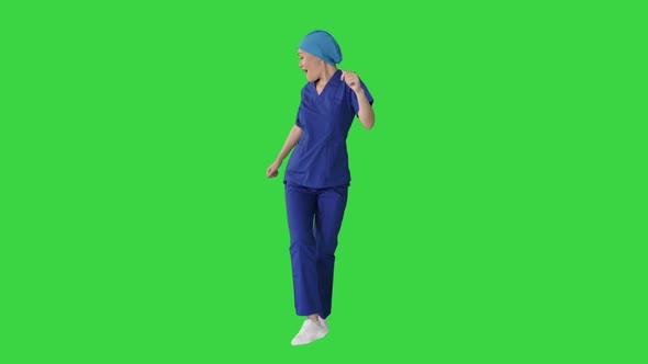 Girl Doctor Is Dancing and Walking on a Green Screen, Chroma Key.