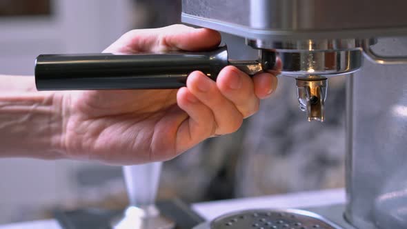 Barista Putting Portafilter in Coffee Machine for Making Espresso