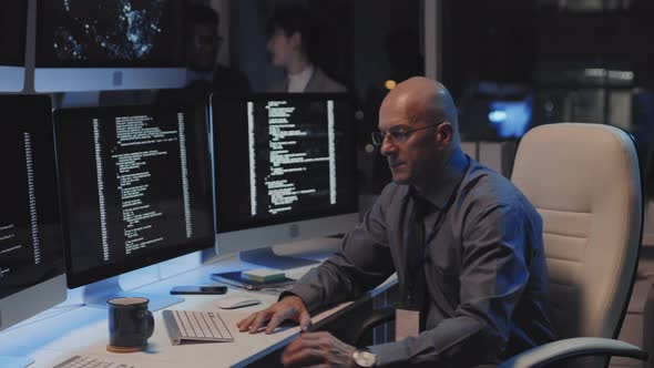 IT Department Manager Posing in Dark Office