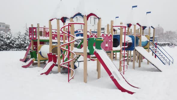 Children playground covered with snow in winter.