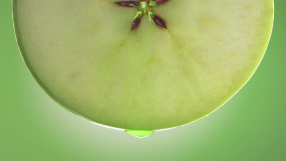 Flowing Green Apple Juice From Apple Slice  Macro Shot in Slow Motion