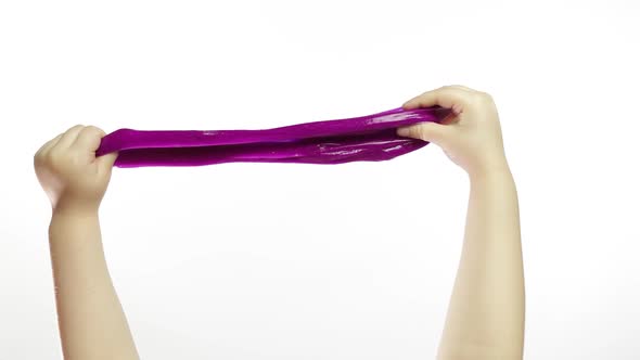 Child Hands Playing Oddly Purple Slime on White Background. Antistress