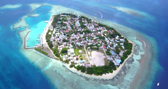 Luxury flying travel shot of a sandy white paradise beach and aqua blue ocean background