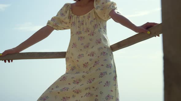 Relaxed Woman Leaning Railings on Seashore