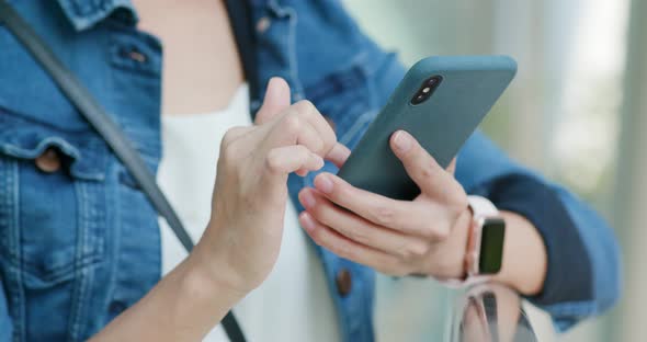 Woman work on mobile phone in city