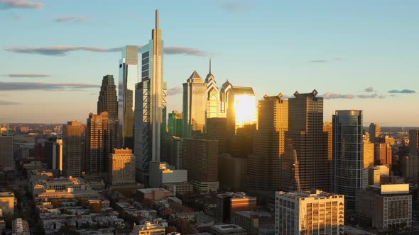 Aerial drone pull away view of the downtown Philadelphia skyline featuring tall, glass skyscrapers a
