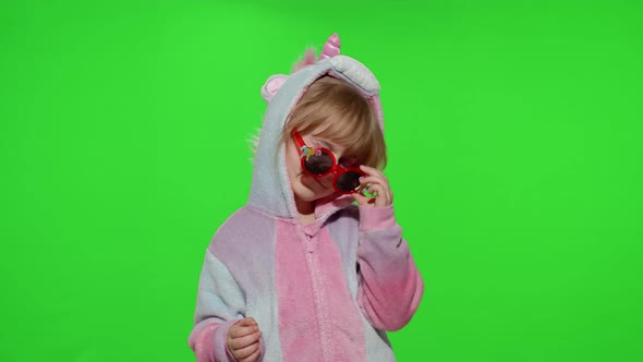 Little Child Girl Smiling Dancing Winking Celebrating in Unicorn Pajamas Costume on Chroma Key