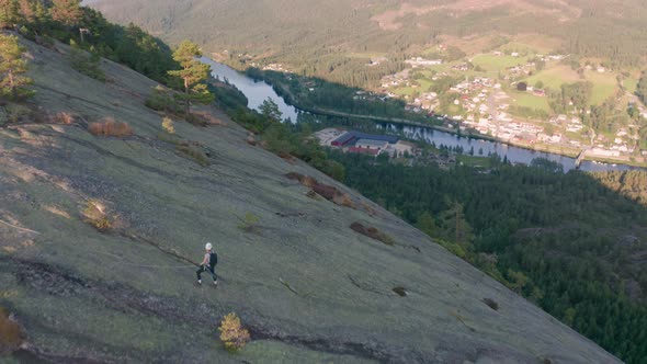 Drone Over Rock Climber Looking Into Valley From Mountainside